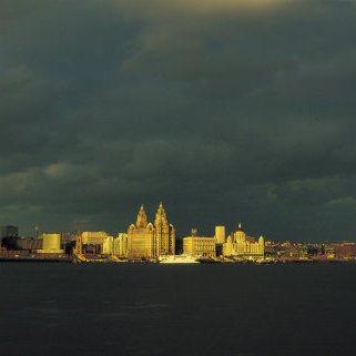 LIV021 Liverpool UNESCO World Heritage Site Liverpool Waterfront dappled with light as a storm front moves across Guy Woodland 1989-2011