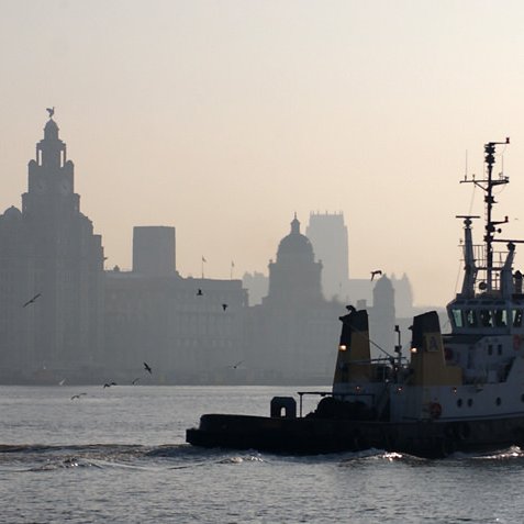 B010-011 Liverpool UNESCO World Heritage Site Shipping races out of the estuary on the fast tide - here a returning tug Guy Woodland 1989-2011